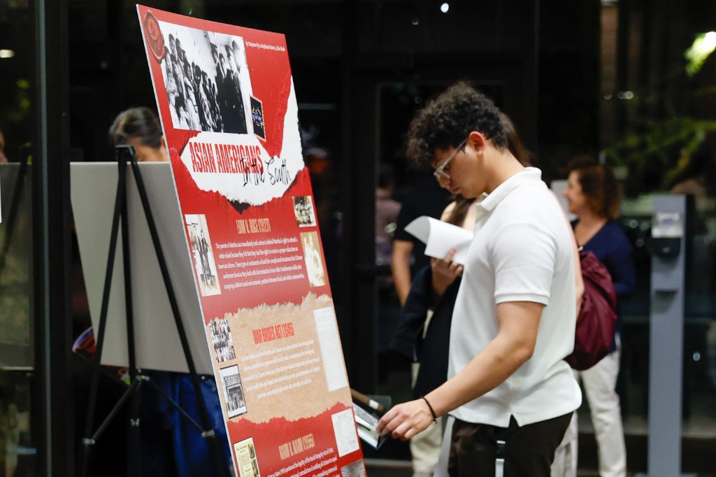 Attendee viewing the Asian Americans in the South research poster